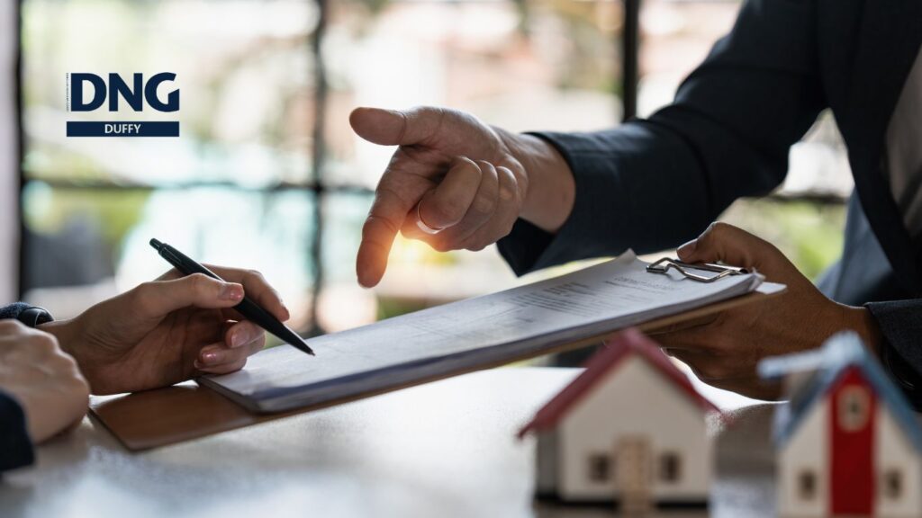hands passing a real estate contract in dundalk