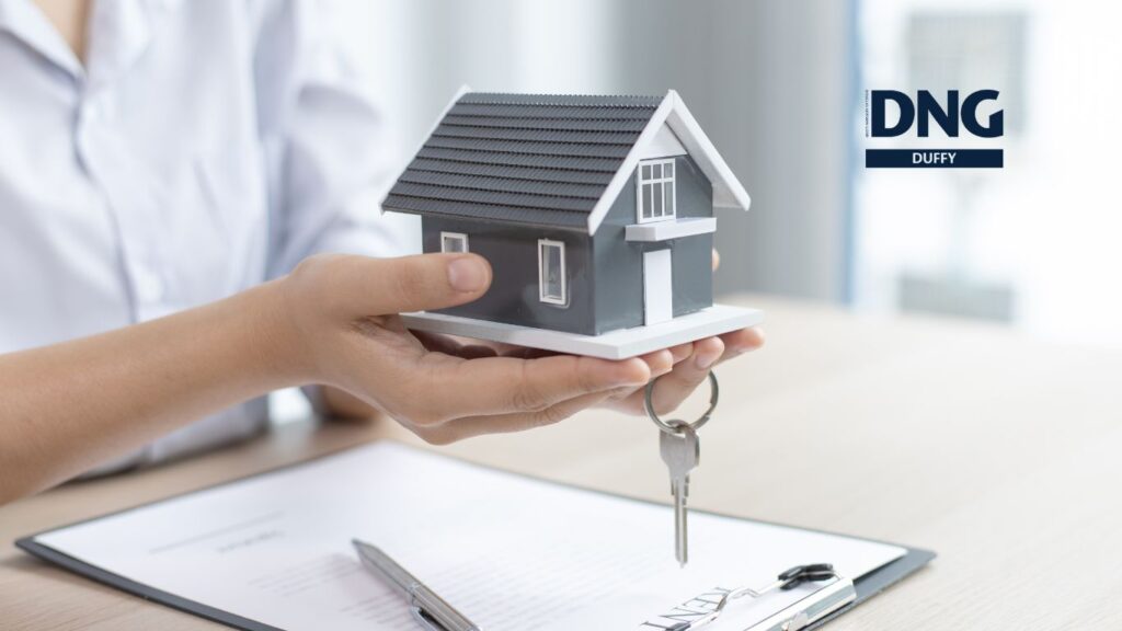 miniature house model in a real estate agents hands