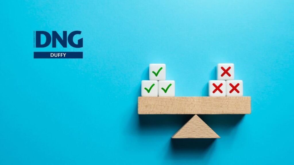 dice balanced on a wooden pendulum scale