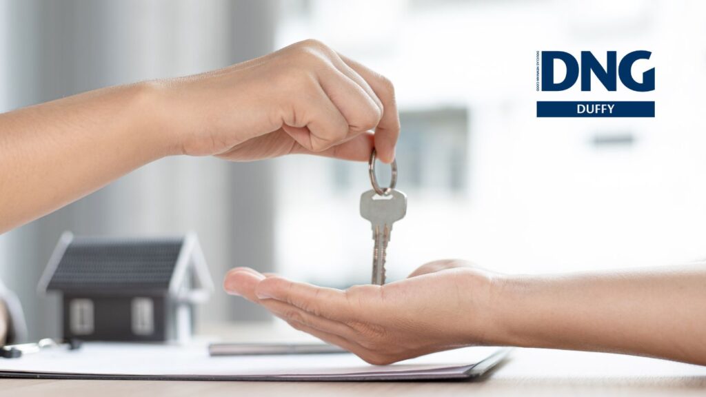 house keys being handed to an open palm