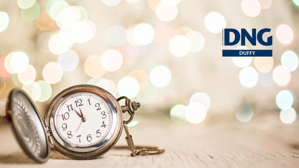 pocket watch with Christmas lights in background